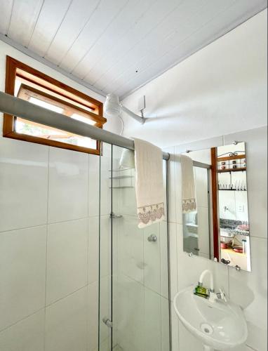 a bathroom with a shower and a sink at Vila Vasconcelos in Itacaré