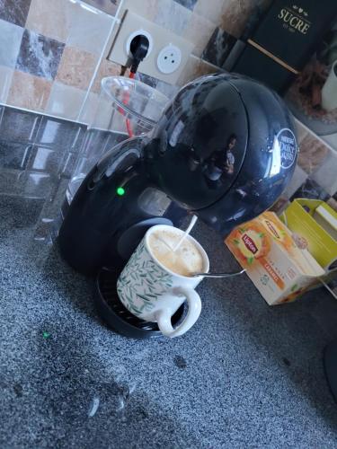 a stuffed elephant holding a cup of coffee at Le Refuge d'Heva in Salazie