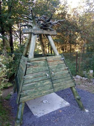 a wooden chair with a sign on top of it at Pod Magnolią in Targanice