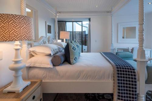 a bedroom with a large bed with pillows at The Upper Deck Penthouse Plettenberg Bay in Plettenberg Bay