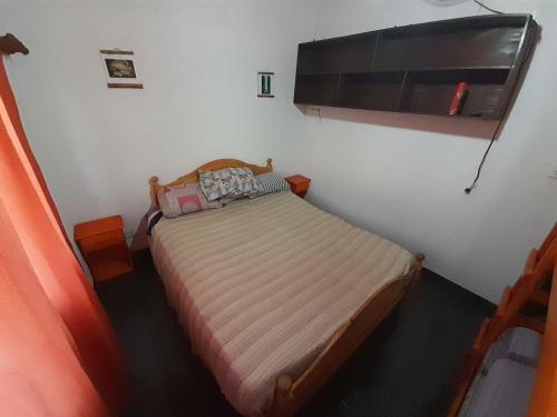 a small bedroom with a bed in a room at Los trevi in Rosario