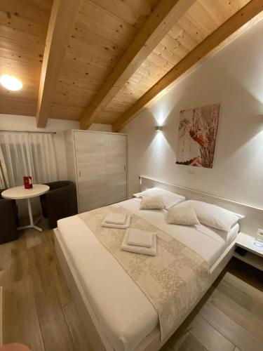 a bedroom with a large bed with two towels on it at B&B-Ld in Pula