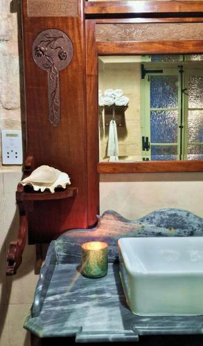 a room with a table and a mirror and a table sidx sidx sidx at Myrtle Suite - Authentic Valletta Experience in Valletta