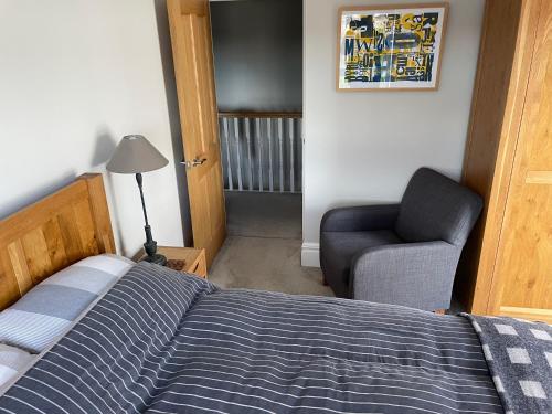 a bedroom with a bed and a chair at Private Room in Saintfield in Saintfield