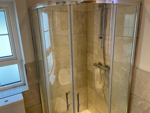 a shower with a glass door in a bathroom at Private Room in Saintfield in Saintfield