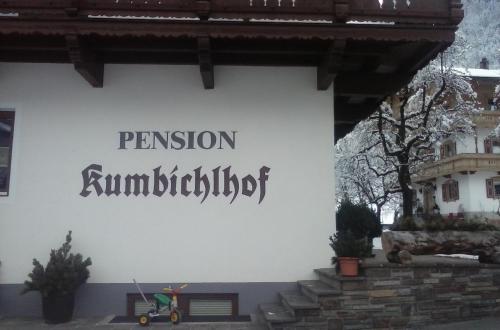 a sign on the side of a building with a scooter on it at Pension Kumbichlhof in Mayrhofen