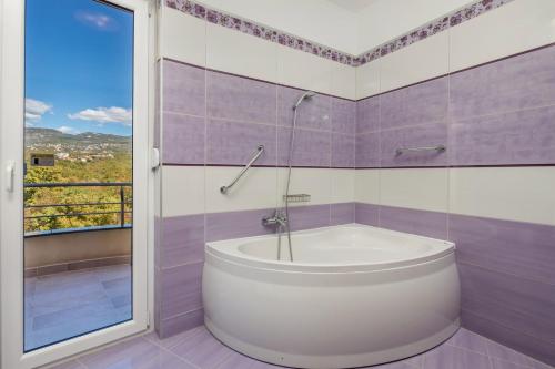 - białą wannę w łazience z oknem w obiekcie Luxury Villa Oštro with pool w mieście Kraljevica