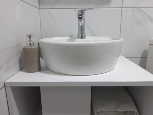 a bathroom with a white sink on a counter at Vila Silia in Skopje