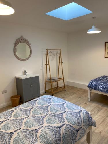 a bedroom with a bed and a mirror on the wall at Island town Apartment in Enniskillen