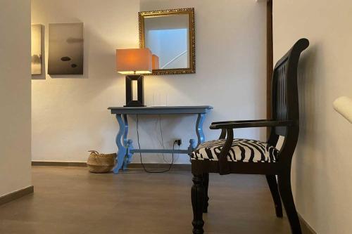 a room with a chair and a table with a mirror at CABARETE BEACH HOUSES the NANNY ESTATES in Cabarete