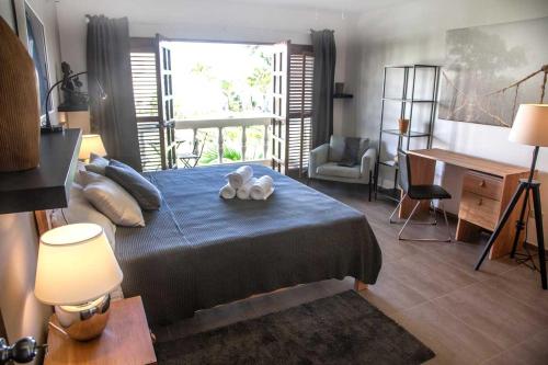 a bedroom with a bed with two stuffed animals on it at CABARETE BEACH HOUSES the NANNY ESTATES in Cabarete