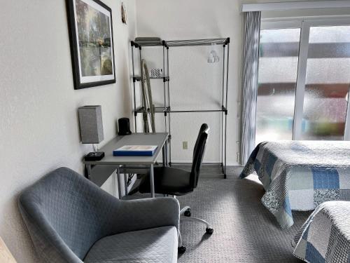a bedroom with a desk and a bed and a chair at Leah's Homestay in Hoquiam in Hoquiam
