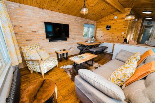 a living room with a couch and a tv at Low Moor Lodge in Scarborough
