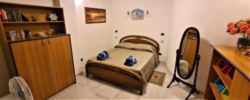 una piccola camera con letto e specchio di Sea and Blue Sky 2-A a Calimera