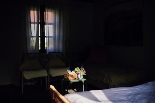 a bedroom with a bed and a table with a basket of flowers at Kurdějov 52 in Kurdějov