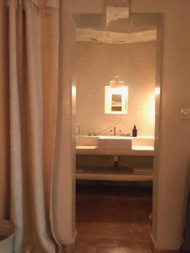 a bathroom with a sink and a mirror at Dar Zahia in Taroudant