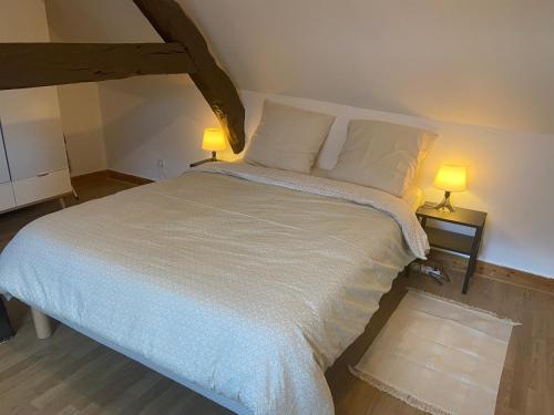 sypialnia z dużym łóżkiem z 2 lampami w obiekcie Le Bassam, proche aéroport w mieście Tillé