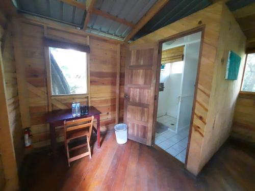 an inside view of a cabin with a desk and a bathroom at Mombacho Lodge in Granada