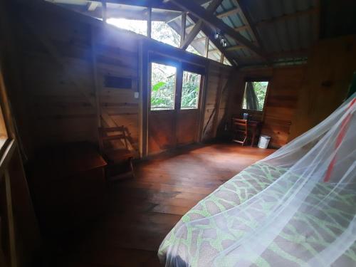 a bedroom in a wooden house with a bed at Mombacho Lodge in Granada