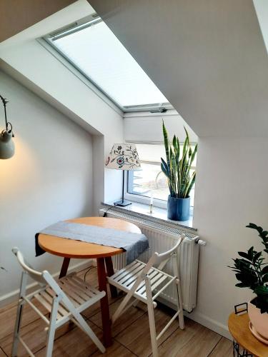 a skylight in a room with a table and chairs at Apartament 252 in Kielce