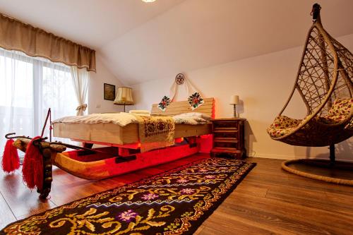 a bedroom with a bed and a swing at Gradina Lu' Ion - Adults Only in Vişeu de Sus