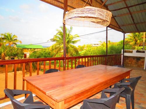a wooden table and chairs on a deck at Moz T's Lodge in Inhambane