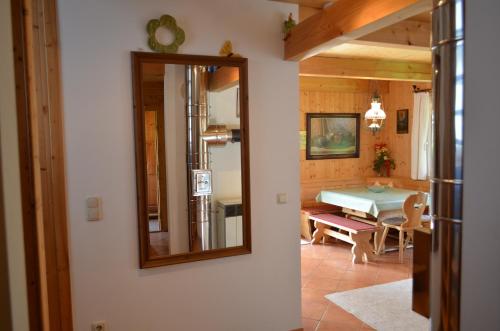 a mirror on the wall of a room with a table at Ferienhaus Kreischberg in Sankt Lorenzen ob Murau