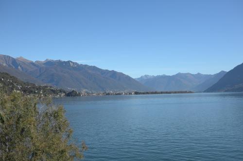 a large body of water with mountains in the background at Art Hotel Ristorante Posta Al Lago in Ronco s/Ascona - Porto Ronco