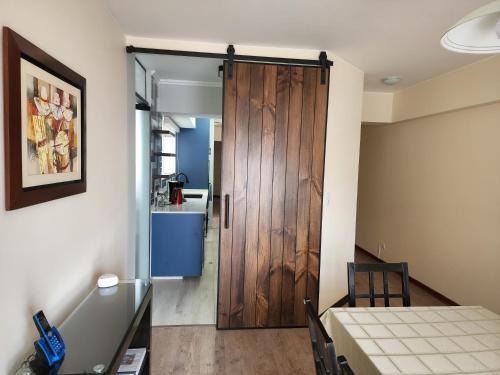 a sliding door in a room with a table at 4BR Quiet Apartment Miraflores Larcomar in Lima