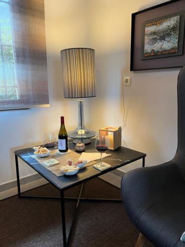 une table avec deux verres de vin et une lampe dans l'établissement Los acebos el atico, à Gallejones