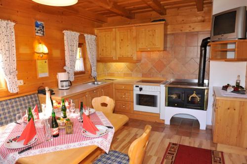 a kitchen with a table and a stove top oven at Bioblockhaus Katschberg in Katschberghöhe