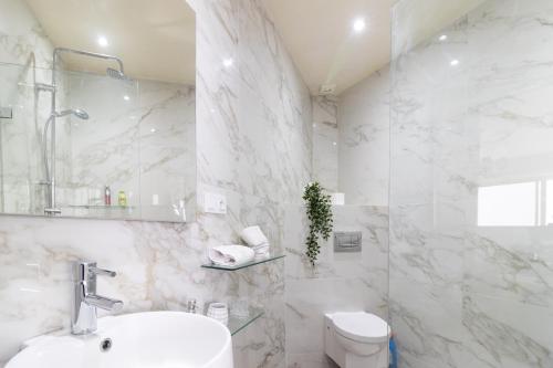 a white bathroom with a sink and a toilet at Maison Simonetta in Oualidia
