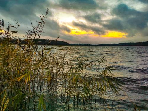 a view of a body of water with a sunset at Ostoja Stacze in Stacze