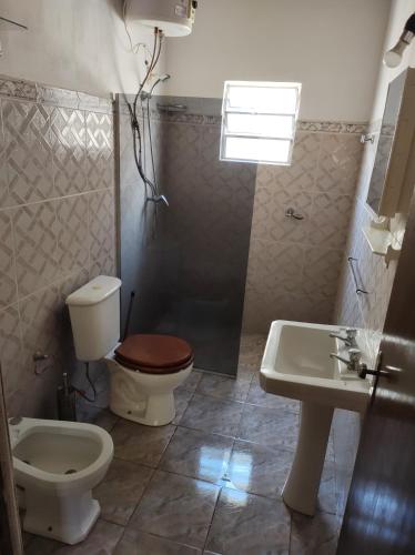 a bathroom with a toilet and a sink at Casa BELLAGIO in Barra del Chuy