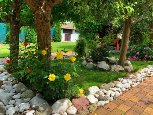 a garden with rocks and flowers in a yard at CASA LUI MOȘU in Alba Iulia
