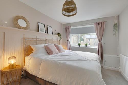 a bedroom with a large bed with a window at Springvale in Sheffield
