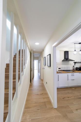 a hallway leading to a kitchen and staircase in a house at Apartamentos San Lazaro in Santiago de Compostela