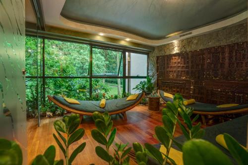 a room with a hammock and a large window at Farmona Hotel Business & SPA in Kraków
