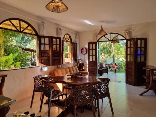 a dining room with a wooden table and chairs at Casa Praia dos Anjos in Barra Grande