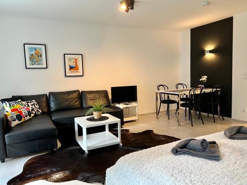 a living room with a couch and a table at Jutta Deluxe Apartment #301 in Bad Reichenhall