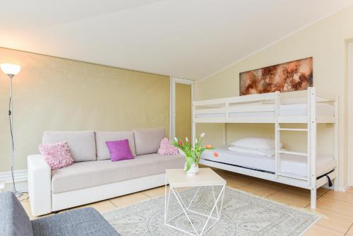 a living room with a couch and a bunk bed at Vila Laurus in Palanga