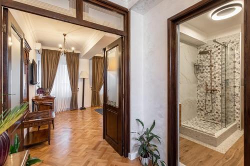 a hallway with a large glass door in a house at Clucerului Arc De Triomphe in Bucharest