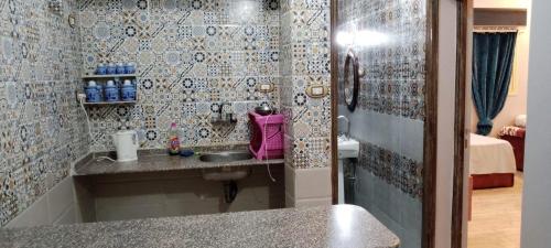 a bathroom with a sink in a room at Winji Guest house in Aswan