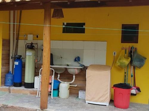 a bathroom with a sink and a yellow wall at Casa Praia dos Anjos in Barra Grande