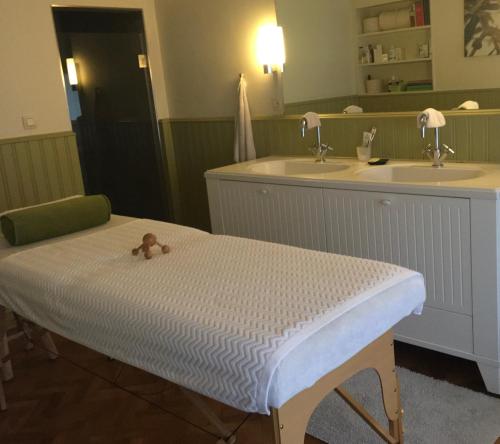 a hospital bed with a teddy bear sitting on it at Authentieke privé-kamer bij Karen in Beveren