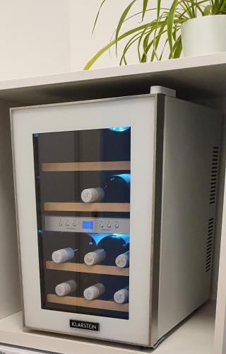 a television with wine bottles in a room at Apartman Eden in Rožnov pod Radhoštěm