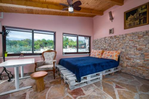 a bedroom with a bed and a stone wall at Istrian Tavern next to the Pool in Banjole