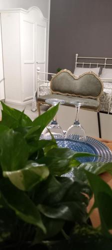 a plant in front of a table with a chair at Loft Ballarò in Palermo