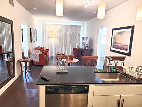 a kitchen and living room with a counter top at Venice Beach luxury Apartments minutes to The Marina And Santa Monica limited time free parking in Los Angeles