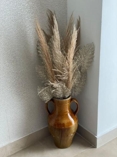 a vase with feathers in it next to a wall at Villa Franko Baška Voda in Baška Voda